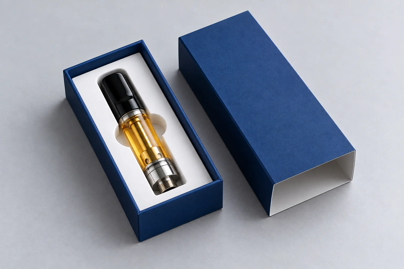 Vape cartridge box with a die cut insert holding a filled cartridge upright